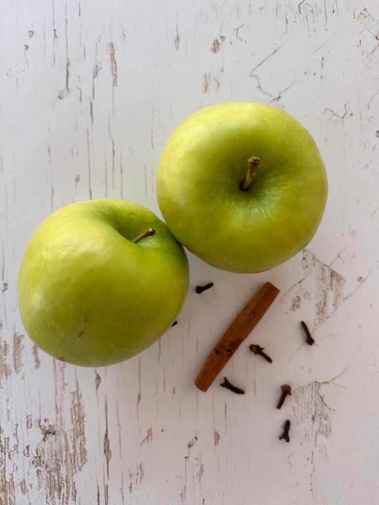 Add a steaming pot of water with apples, cinnamon, and cloves, releasing the comforting scents of fall into the air.