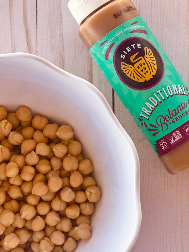 Chickpeas flavored with Botana sauce to create a healthy flavorful potato dish platter served over sprouts.