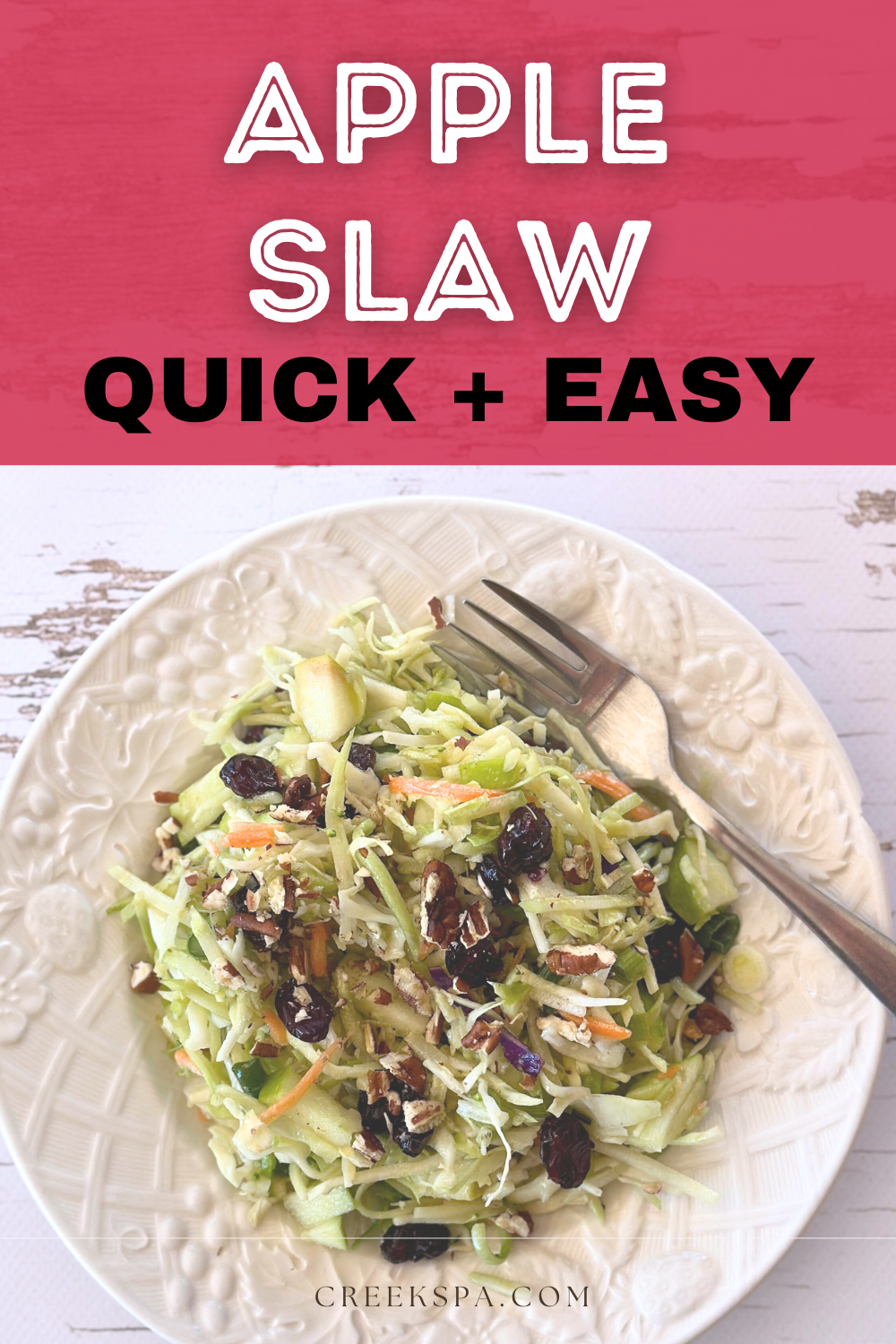 A vibrant bowl of Sweet & Tangy Apple Slaw featuring shredded broccoli slaw, cabbage, crisp apple slices, dried cranberries, and crunchy pecans, all tossed in a light apple cider vinaigrette.