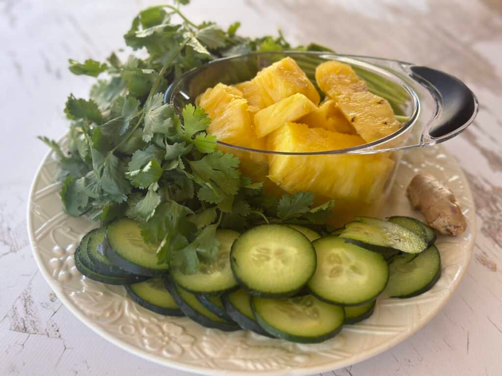 Vibrant, fresh ingredients including pineapple, cilantro, lime, and coconut water laid out and ready for blending.