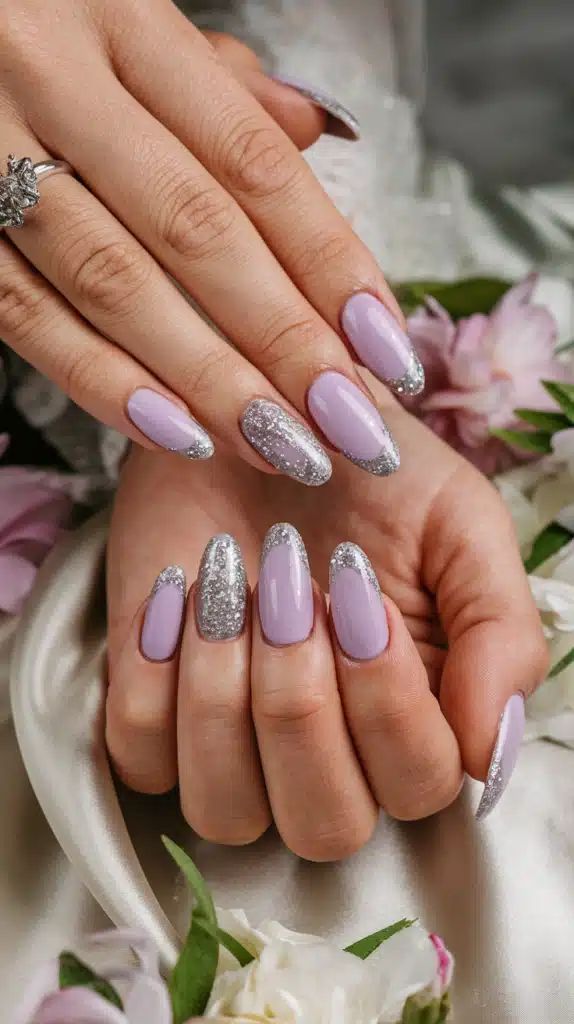 Elegant pastel lilac nails with a subtle silver glitter accent, creating a magical, soft springtime manicure.